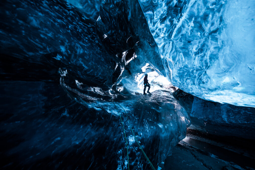 Mountain,Climber,Standing,Inside,An,Icecave,In,A,Glacier,In