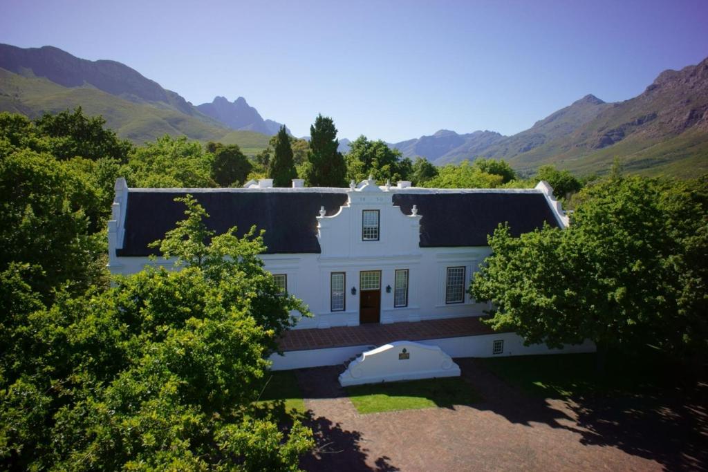 Historisch Lanzerac Wine Estate in Stellenbosch, omringd door wijngaarden en bergen.
